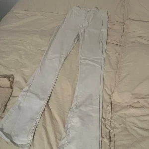 Vita bootcut jeans - Snygga ljusbeige jeans med bootcut passform och klassiska fickor bak från Zara. Byxorna har en stilren look och är tillverkade i ett mjukt bomullsmaterial som känns skönt mot huden. Perfekta för dig som gillar en clean och enkel stil.