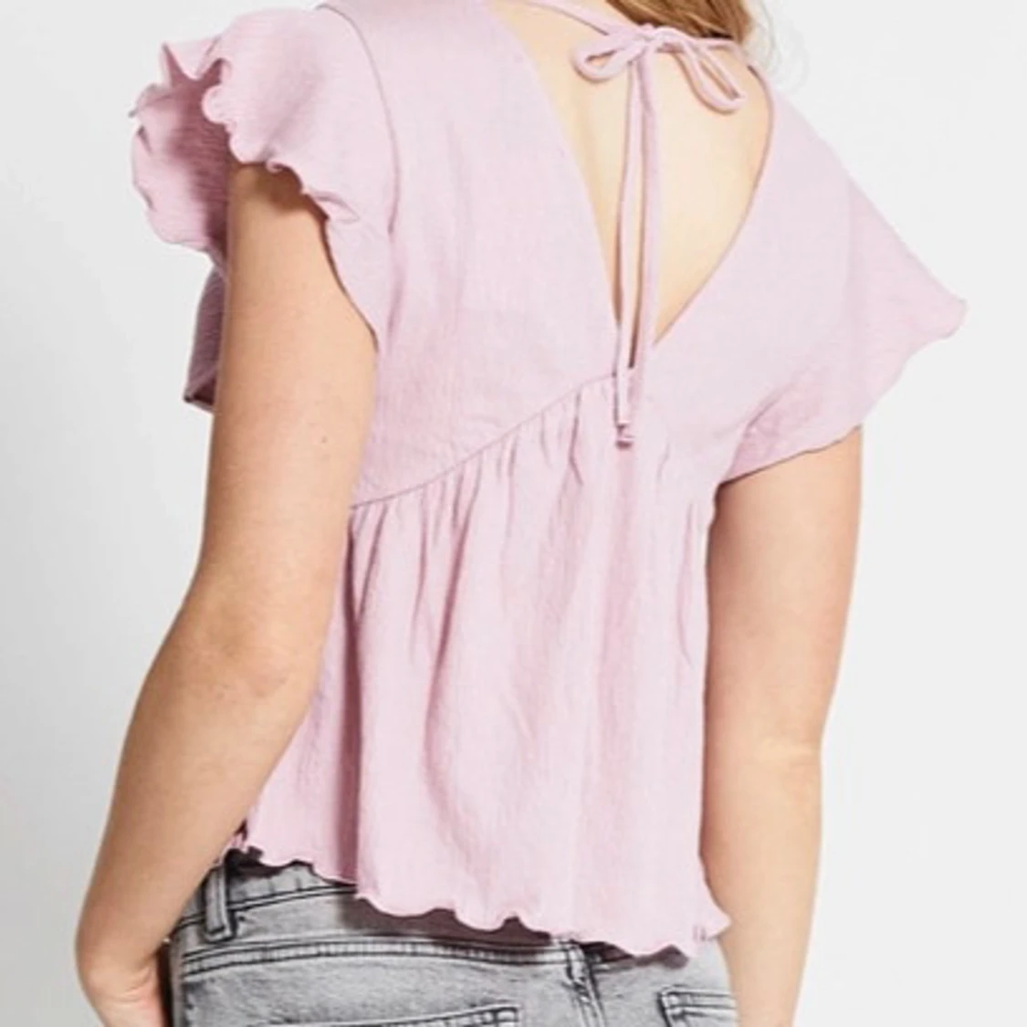 Ljusrosa blus med volangärmar - 1