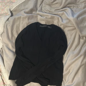 Svart långärmad tröja från lager157 - Säljer en svart långärmad tröja från The Black Label Collection (Lager157) storlek S. Tröjan har v-ringning och är tillverkad i ett mjukt, tunt material . 
