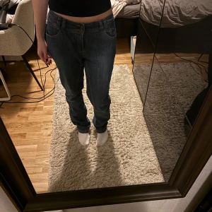 Mörkblå raka jeans - Säljer ett par mörkblå jeans med klassisk rak passform och normal midja. Jeansen har fem fickor, snygga sömmar och stängs med dragkedja och knapp. Perfekta till en avslappnad stil och funkar året runt.
