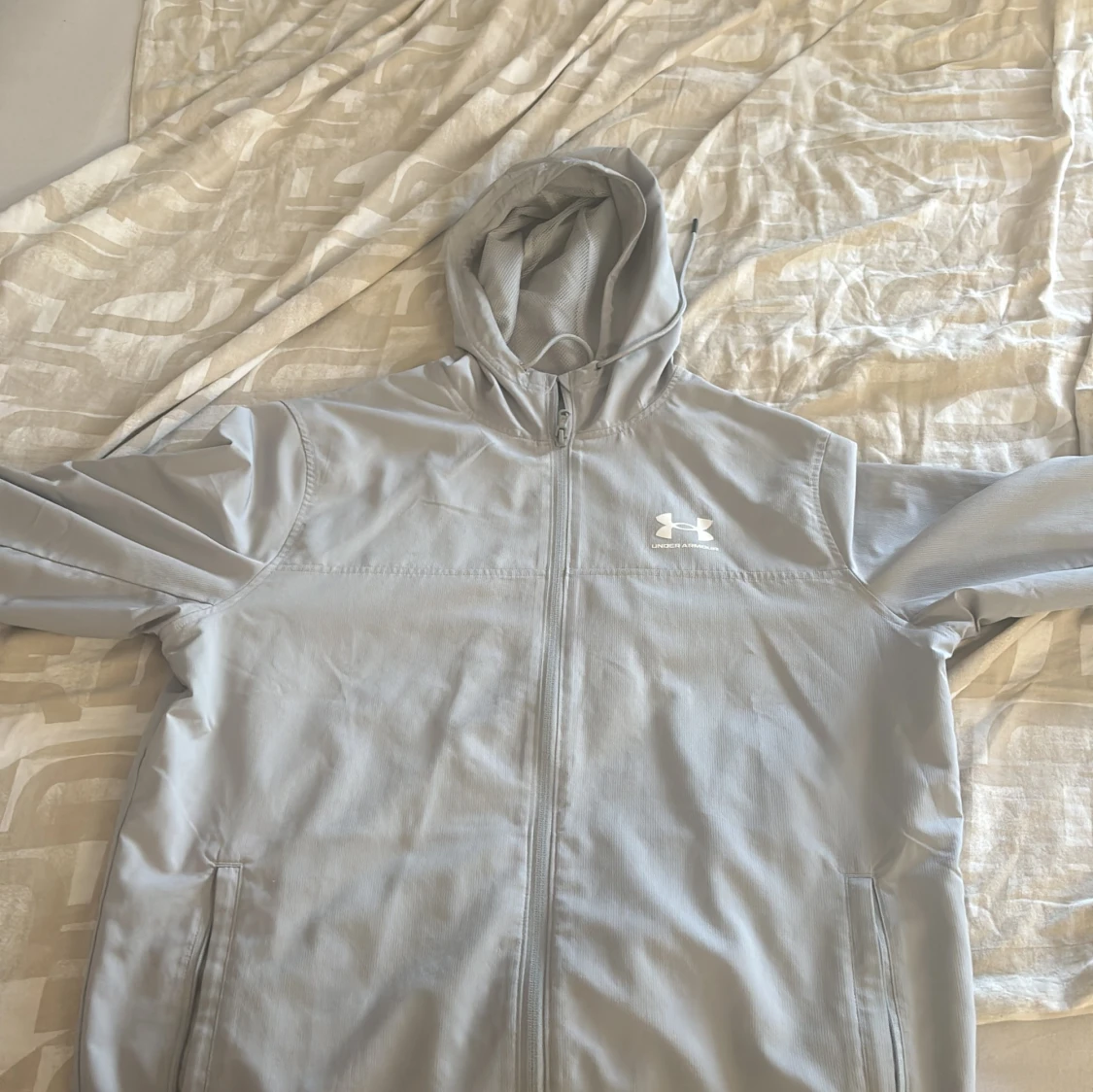 Ljusgrå vindjacka från Under Armour
