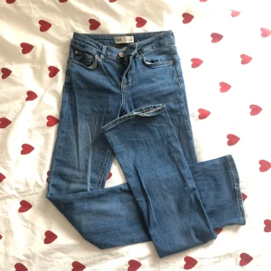Blå jeans från Zara, storlek 32 - Snygga blå jeans från Zara i klassisk femficksmodell. Mid/low waist. Flare/bootcut modell. Använda ett par gånger, lite slitage längst ner.