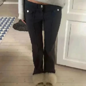 Svarta byxor med knappar - Snygga svarta byxor med låg midja och raka/bootcut ben. 