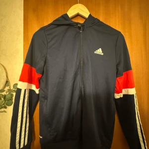 Adidas marinblå tracksuit! - Säljer en marinblå adidas tracksuit jackan har även huva och en hel dragkedja perfekt för alla väder men även för dig som gillar sportig bekväm stil och vill sticka ut lite extra😊