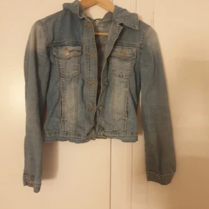Klassisk blå jeansjacka från IYSH - Säljer en klassisk blå jeansjacka från IYSH i storlek S. Jackan har två bröstfickor med knappar, snygga söm-detaljer och en tidlös krage. Perfekt att slänga över en hoodie eller t-shirt för en chill look.