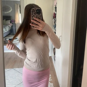 Beige långärmad tröja från Lager 157 - En stilren beige långärmad tröja från Lager 157 med rund halsringning och ribbade muddar. Tröjan är tunn och har en klassisk passform som funkar perfekt till jeans eller kjol. Enkel och snygg för dig som gillar en clean look.