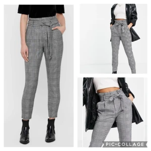 Grå rutig byxa med knytband - Snygga grå rutiga byxor med hög midja och knytband i midjan. Byxorna har en elegant och stilren design med en smickrande passform. Perfekta för en chic look.