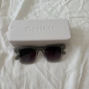Grå CHIMI solglasögon 04 grey - Säljer ett par stilrena solglasögon från CHIMI i transparent grått. Moddel är 04, Inga defekter på själva glasögonen! De passar båda killar och tjejer! Box till glasögon tillkommer och även en liten duk som man kan putsa de med💕