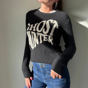 Svart cashmere tröja från from future  - Cool svart stickad tröja med vit text 'GHOST HUNTER' på bröstet i stor, edgy font. Tröjan är köpt från from future för ungefär 2500kr 