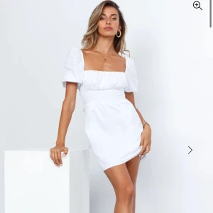  Vit kortklänning med puffärmar (oanvänd) - Säljer en söt vit kortklänning med puffärmar och en öppen rygg. Klänningen har en knytning bak som ger en fin detalj. Perfekt för student! Helt oanvänd med etiketter krav! Skriv för privata bilder! Nypris 1 150kr (85 $)