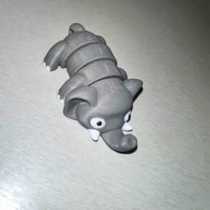 Grå 3D-printad elefantfigur - Charmig grå elefantfigur skapad med 3D-printing. Den har en segmenterad kropp som ger den en flexibel och lekfull design. Perfekt som dekoration eller leksak.