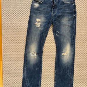 Blå jeans från G-Star RAW - Snygga blå jeans från G-Star RAW med slitna detaljer och en cool vintage-look. Storlek 29/34. Dem är använda så slitage förekommer.