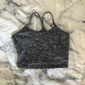 Gråmelerad träningslinne från SHEIN - Supersnygg gråmelerad träningslinne från SHEIN med smala axelband och croppad passform. Perfekt till träning eller chill outfits. Tunt och stretchigt material i polyester och elastan som sitter skönt mot kroppen.