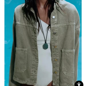 Grön jeansjacka  - Säljer denna jättesnygga och otroligt populära olivgröna jeansjacka från Zara. Jackan har stora fickor framtill, klassisk krage och knäppning med metallknappar. Perfekt för sensommaren, hösten eller våren. Jackan har kommit till användning men ser så gott som ny ut med inga defekter som förekommit efter köpet. 