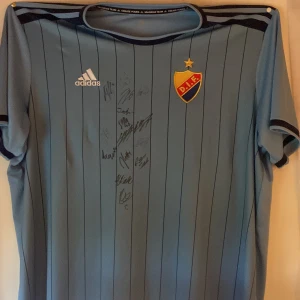 Djurgården fotbollströja  - Säljer en djurgårds fotbollströja, den är i bra skick då den bara används för att ha på väggen. Men har några små hål runt axlarna för nålarna. Nypris 1100