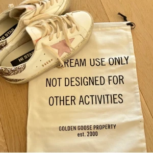 Golden Goose skor - Snygga Golden Goose sneakers med en rosa stjärna på sidan och glittrig häl. 