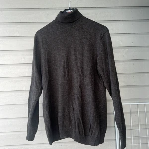 Mörkgrå polotröja från Matinique - Säljer en stilren mörkgrå polotröja från Matinique. Tröjan är långärmad och tillverkad i ett mjukt material som passar perfekt för kyligare dagar. Perfekt för en elegant och avslappnad look.