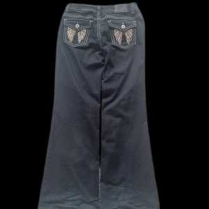 Svarta jeans från Arizona - Svarta jeans med breda ben vita sömmar pch broderade detaljer på bakfickorna💕 Det står ingen storlek i jeansen men skulle säga att de passar S💕 Lite slitna vid benen💋 Skriv om ni vill ha mått