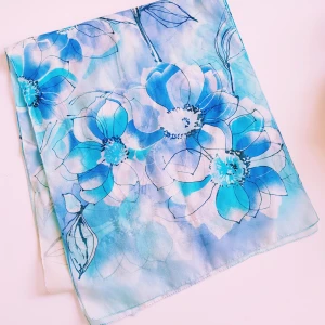 Blommig blå sidenscarf - Snygg och tunn halsduk i siden med stora blommor i olika blå nyanser och vitt. Scarfen har ett luftigt och lätt material som ger en fräsch känsla. Perfekt att slänga över axlarna för en cool touch till din outfit.  Helt skick dock obehandlade fläckar