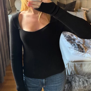 Svart ribbad långärmad tröja - Säljer en svart, ribbad långärmad tröja med djup, fyrkantig ringning. Tröjan är figurnära och har långa ärmar med slits. Från Gina Tricot i storlek S. Hör av dig vid frågor☺️🫶🏽
