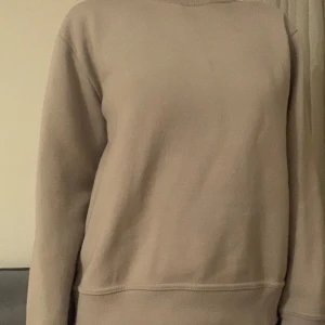 Beige tröja från Zara - Säljer en stilren beige tröja från Zara. Den har en enkel design med långa ärmar och rund halsringning. Perfekt för en avslappnad look. Tillverkad i ett mjukt material för extra komfort. Ej kommit till mycket användning 