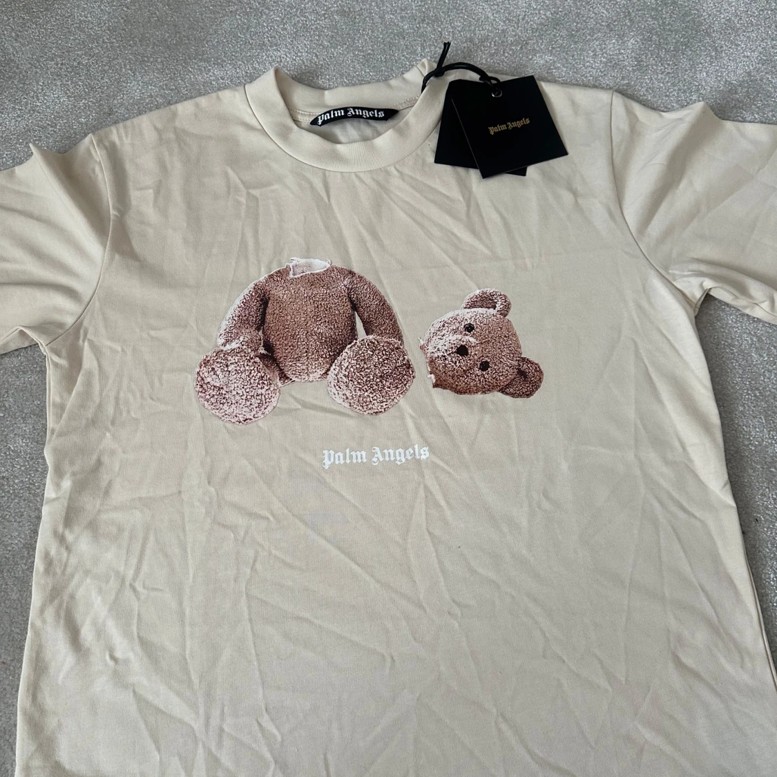 Beige t-shirt med nalletryck från Palm Angels