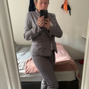 Rutigt kostymset med kavaj och byxa - Använt detta en gång men det är så snyggt på rätt figur. Stl är M . Men jag har mage men på rätt tjej:) Snyggt kostymset från Chicville med rutigt mönster i svart, vitt och grått. Kavajen har en knapp framtill och klassisk krage, byxorna har resår i midjan och snörning. Perfekt för dig som gillar en stilren och trendig look.