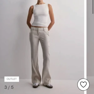 Beiga linnebyxor med bootcut Nelly - Snygga beiga linnebyxor med bootcut-snitt och normal passform. Byxorna har klassiska fickor fram och bälteshällor i midjan. Perfekta för en chill och stilren look, passar lika bra till sneakers som till boots.