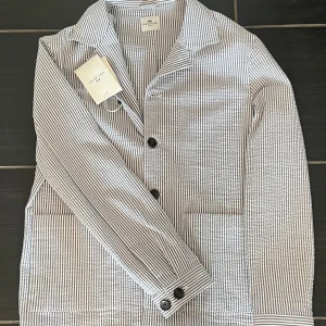 John Henric overshirt - Säljer en helt ny John Henric overshirt!den är helt ny och aldrig använd.  Riktigt snygg till sommaren! Hör av dig vid minsta fråga!       Nypris: 1199
