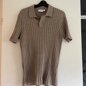 Beige ribbad pikétröja från Kappahl - Snygg piké från Kappahl. Den är aldrig använd men har dock inte kvar prislappen. Skriv för fler detaljer eller bilder😽
