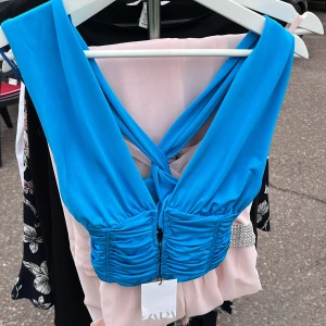 Blå festtopp frön Zara - Blå festtopp från Zara, helt oanvänd med prislapp kvar, i storlek xs. Säljer för 50kr plus frakt, välj gärna instabox om möjligt