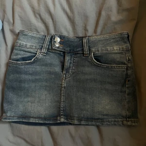 Jeanskjol - Säljer denna jeans kjol från H&M som har dubbla knappar och en sliten jeans färg, sparsamt använd och inga defekter alls. Midjemått är 35x2, men den är väldigt stretchig. Längd på kjolen är cirka 28 cm. Skriv gärna innan ni köper, köp helst med insta box. Skriv för frågor!💓