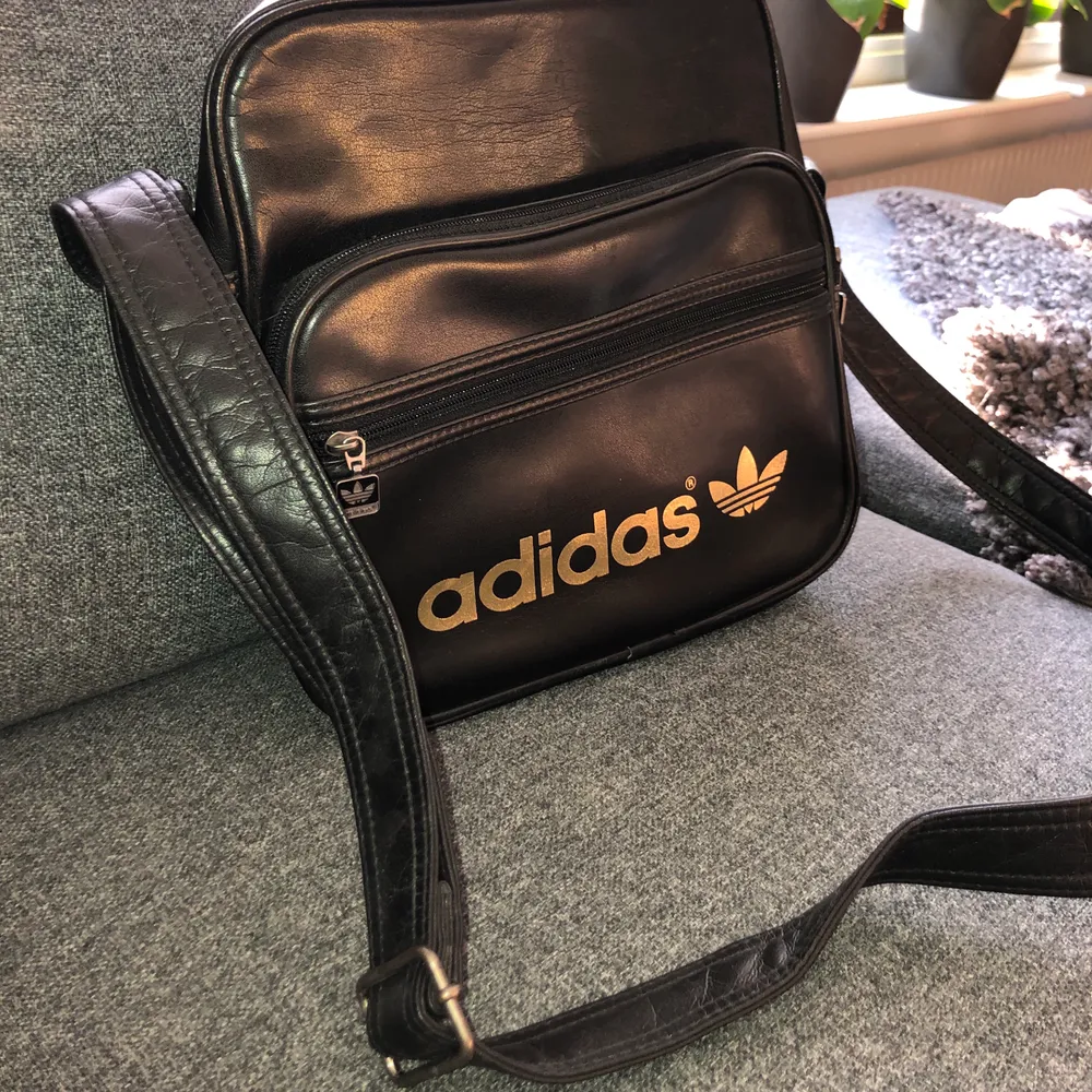 Fin väska från Adidas, perfekt till skolan. Välanvänd men i begagnat skick.  Har ett band man kan ha över axeln.  Köparen står för frakten🦋✨. Väskor.