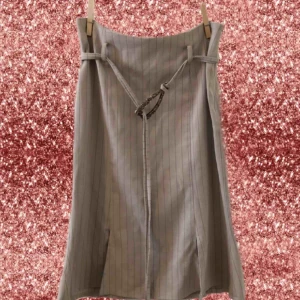  - Vintage 90s pinstripe pencil skirt. Falls below the knees and has four short slits at the bottom. Comes with original belt.  