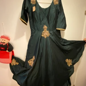 Party wear evening gown - Green coloured evening gown for parties...elegant wear....never used and has a tag...has 5 layers of clothes inside to give an elegant look...has a zip at one side for best fitting...also has 10 cm of space available for alteration