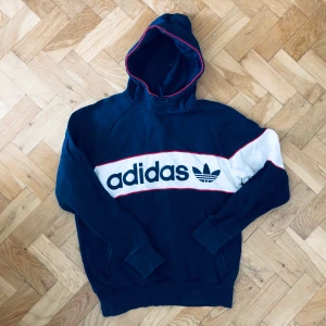 Retro adidas hoodie - Supersnygg retro adidas hoodie i blått, rött och vitt, väldigt 90-talig. Står L i den men motsvarar snarare en M än L!