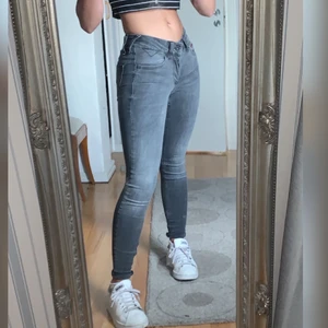 Gråa coola Tommy hilfiger jeans - Mörk grå tajta jeans med ljusare övergångar, normal/låg midja. Väldigt stretchiga så passar alla typer av kroppsformer. ÄKTA TOMMY HILFIGER