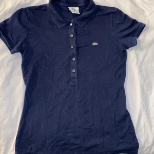Lacoste piké - En äkta Lacoste piké. Den är i använt skick, men verkligen ändå inte dåligt skick! Den går inte att köpa längre och assnygg på. Frakt tillkommer!