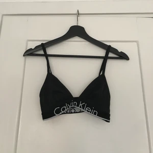 Topp från Calvin Klein - Svart triangeltopp med vit text från Calvin Klein. För liten för mig, är betydligt snyggare när den passar! 