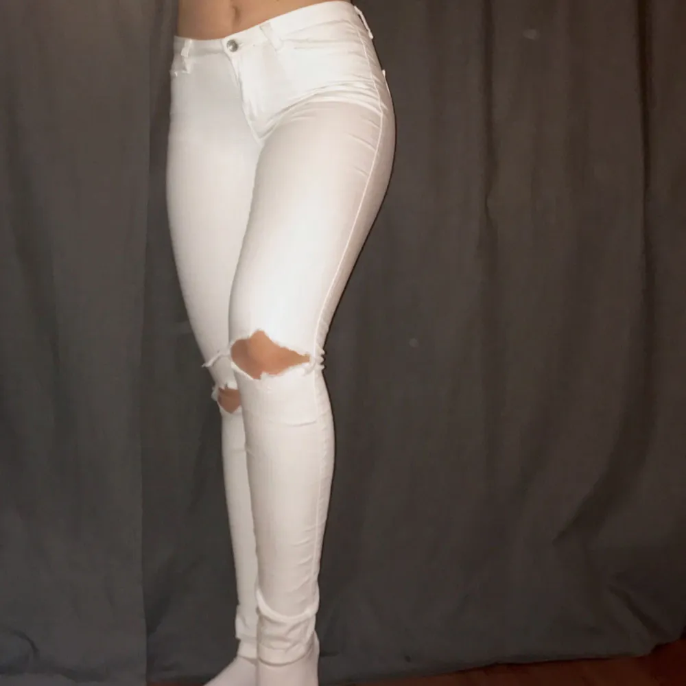 Ett par vita byxor i stretching material med hål i knäna. De är fruktansvärt sköna men kommer inte till användning längre . Jeans & Byxor.