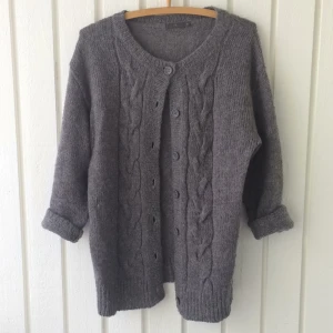  - Mysig stickad kofta inköpt på Åhléns. Väl använd men inga större tecken på det. Saknas en knapp dock. Gjord i akryl och ull men sticks inte:)