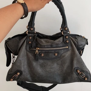 Balenciaga City bag - Säljer min superfina Balenciaga city bag, nu har den två år på nacken och kommer inte längre till användning hos mig.  Väskan har en grön/grå färg, vilket inte produceras längre. Skinnet är lite blekt, men är i superfin kvalite. Personligen har jag gillar den lite ”blekta” looken, men man kan absolut smörja in med lite läderfett om man vill.  Har dessvärre inget kvitto kvar då jag köpt den på Vestiaire Collective. Vid köp kan jag mötas upp i centrala Göteborg alternativt skicka på posten.