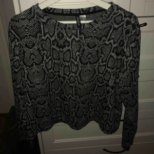  - Collageaktig tröja med ormmönster från hm. Använd några gånger men i bra skick. Passar M-L, sen beror allt på hur man vill att den sitter. Frakt 50kr, pris kan diskuteras