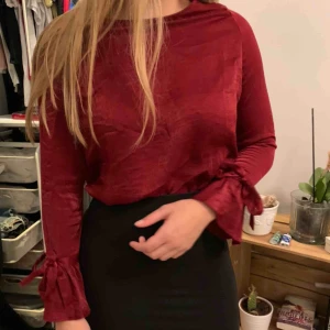  - En supersöt röd, lite julig blus. Materialet är mjukt & den har snörningar vid armarna. Går att både styla upp & ner.  Säljer för att det inte kommer till användning längre. 