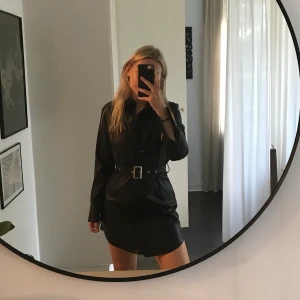 OANVÄND LINN AHLBORGxNAKD LÄDERKLÄNNING - Helt oanvänd fauxskinnklänning från Linn Ahlborgs kollektion med NAKD i storlek 36 med lappen kvar. Från en kollektion som ej finns kvar att köpa, budgivning då intresset är stort. Köparen betalar frakt!