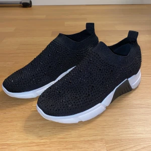 Svarta sneakers - Svarta sneakers med snygga detaljer från Ferrantino collection. Stl 38 i nyskick. Endast använda 1 dag. Jättebekväma och enkla.  Kampanj: KÖP 3 BETALA FÖR 2