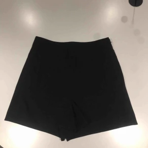  - Svarta kostymshorts i storlek 34.  Köpta för 450 kr. 