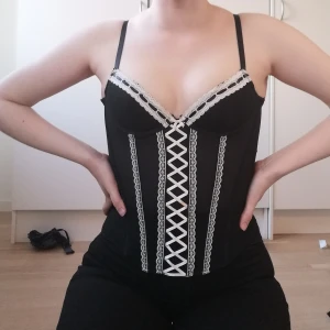 Korsett topp - Superfin korsett i använt men fint skick! Lappen är borta men jag skulle säga att den är ca S-M då den har 3 rader knäppen i ryggen. Gissar på A-kupa, frakt tillkommer😊