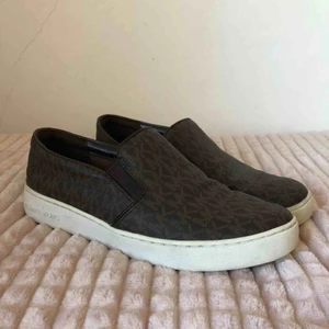  - Michael Kors slip ons Använda men i väldigt fint och fräscht skick! Köptes för ca 1400kr på en Michael Kors butik i USA.