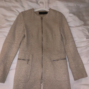 Beige kappa2 - En till snygg beige kappa med dragkedja, använd ett fåtal gånger. Säljer pågrund av förliten